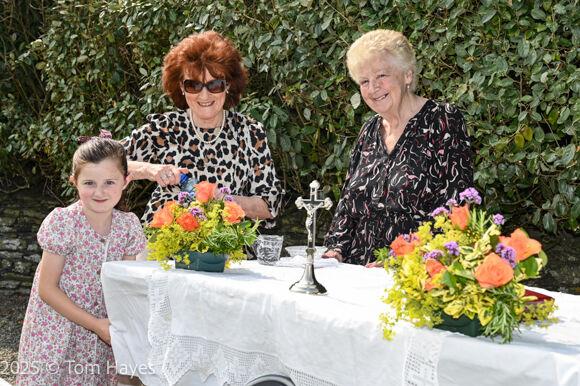 Angela O'Driscoll and her granddaught with Margaret Burke prpeare the altar for the Mass at Our Lady's Well, Ardfield/Rathbarry Parish for the Feast of the Assumption of Our Lady.