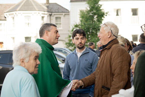 Fr. Marius meets parishioners after Mass